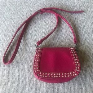 Pink Crossbody purse with studded accents.
